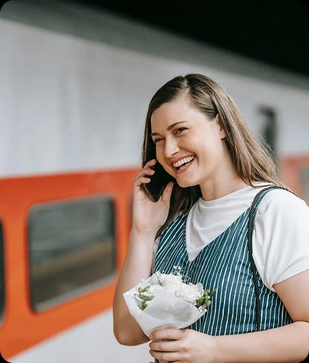 A lady talking on phone with flowers